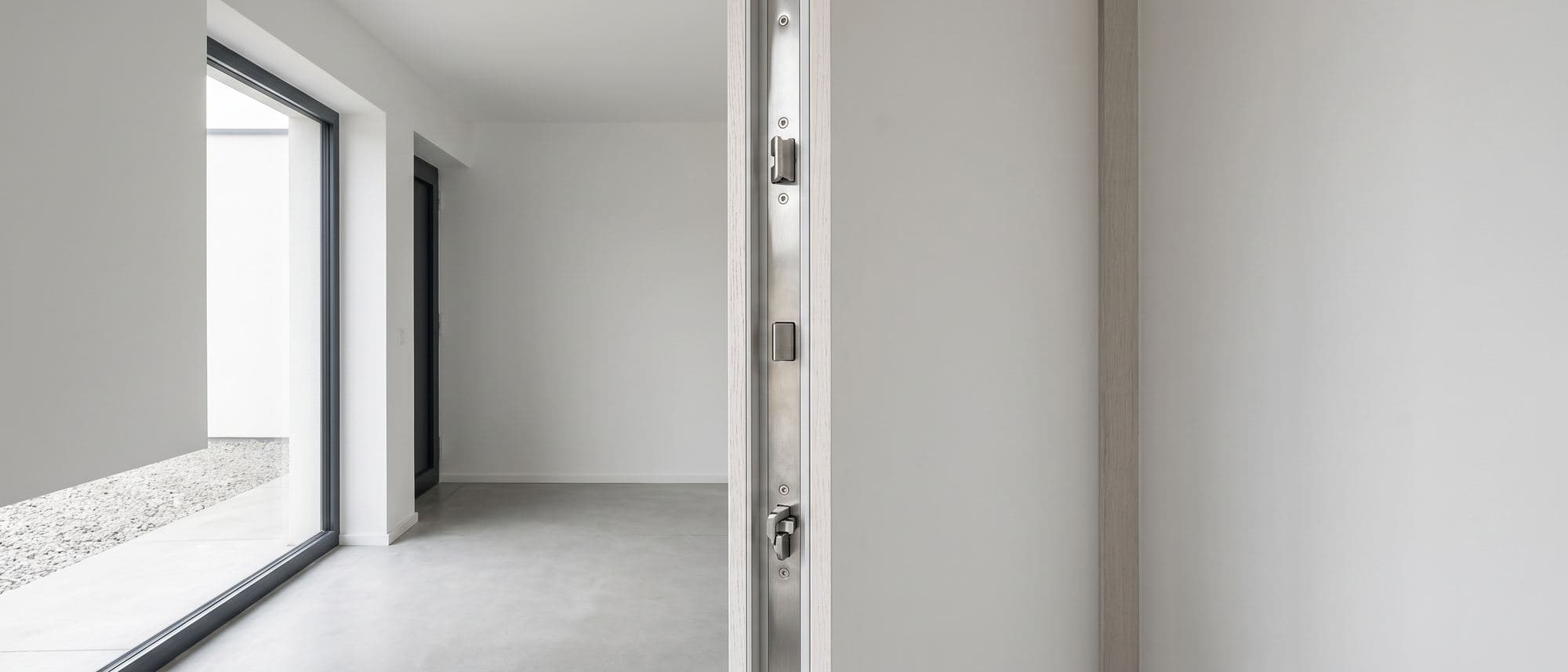Chant d’une porte d’entrée de maison individuelle ouverte, têtière multipoints en inox visible